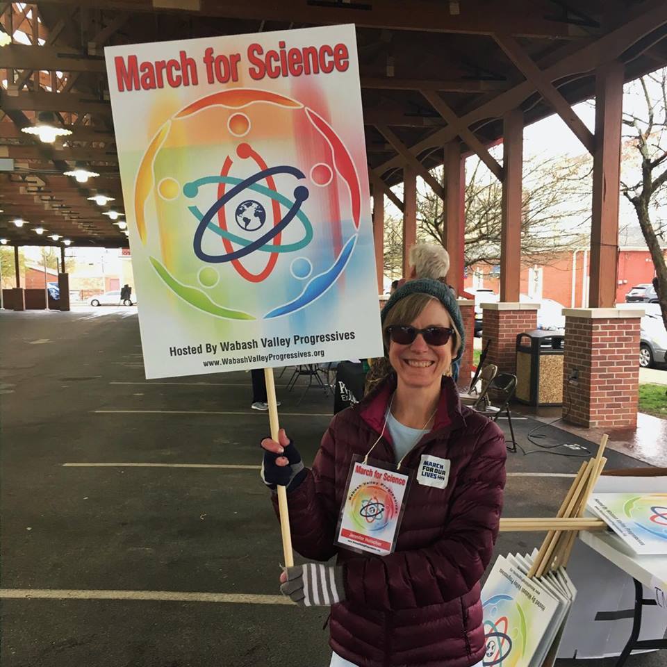 Woman holding sign that reads March for Science hosted by Wabash Valley Progressives